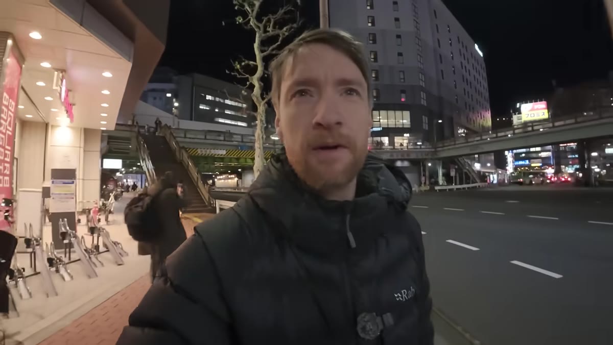 Thomas walking through Tokyo streets after buying essentials
