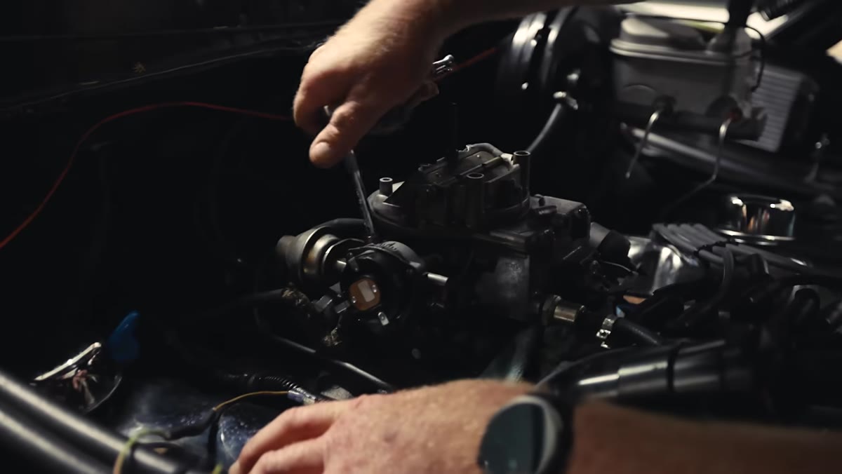 Mechanic explaining carburetor behavior stalling when shifted into gear