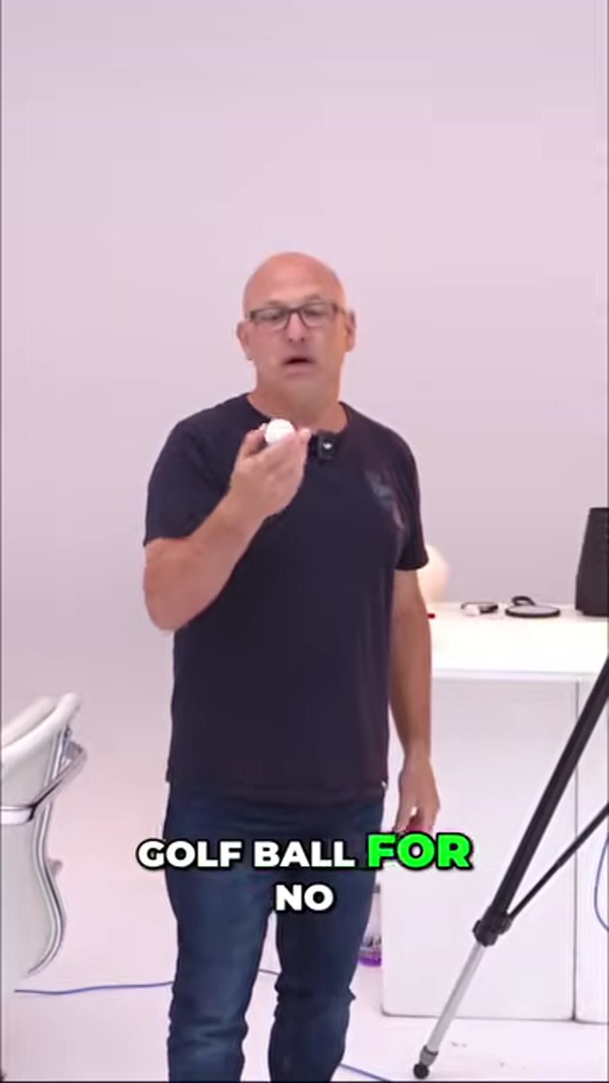 Golf ball centered on white background, unlit