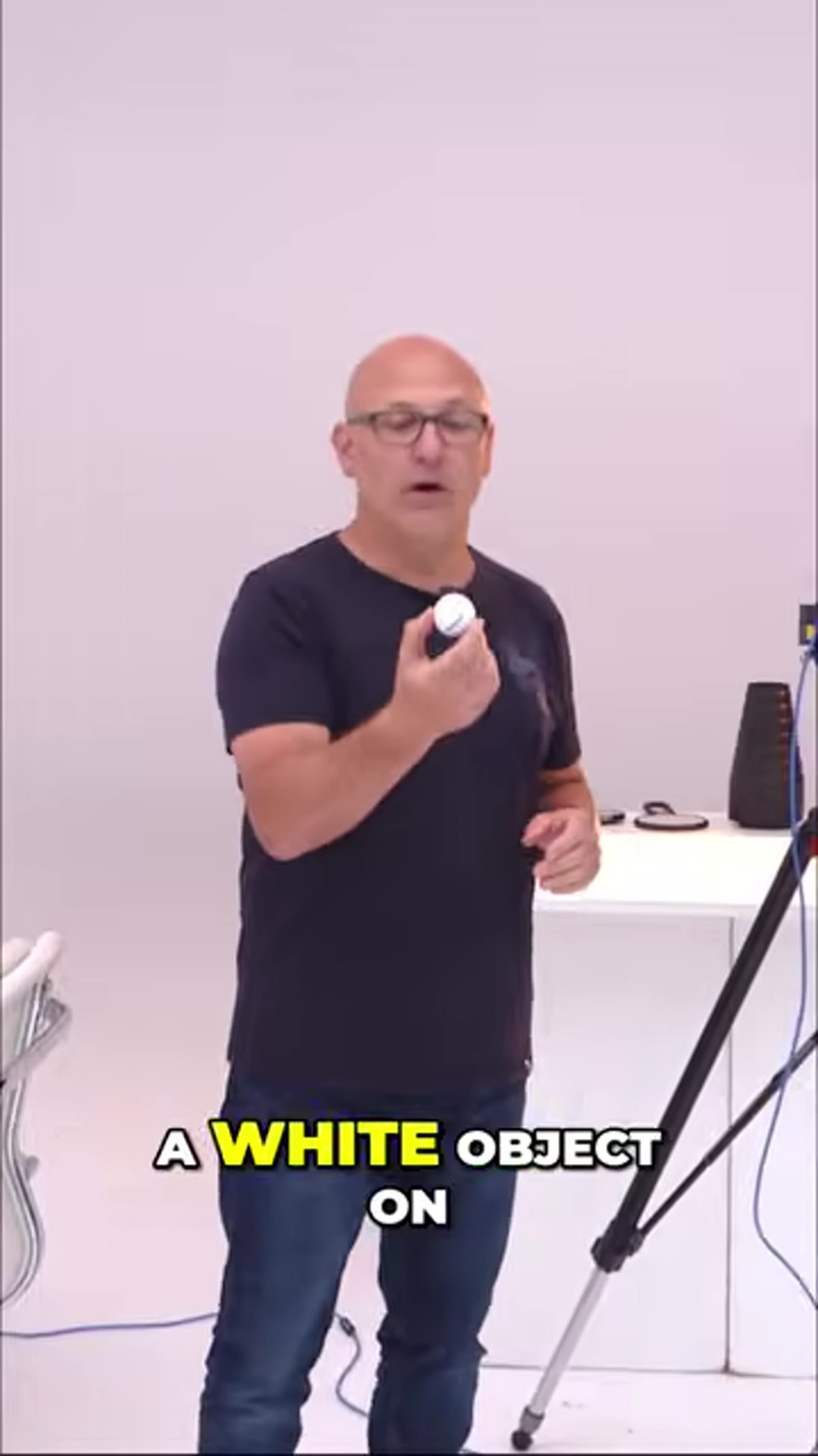 White golf ball placed on white surface, minimal setup