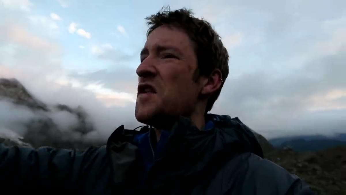 Camera display showing f11, ISO 100 settings on mountain shot