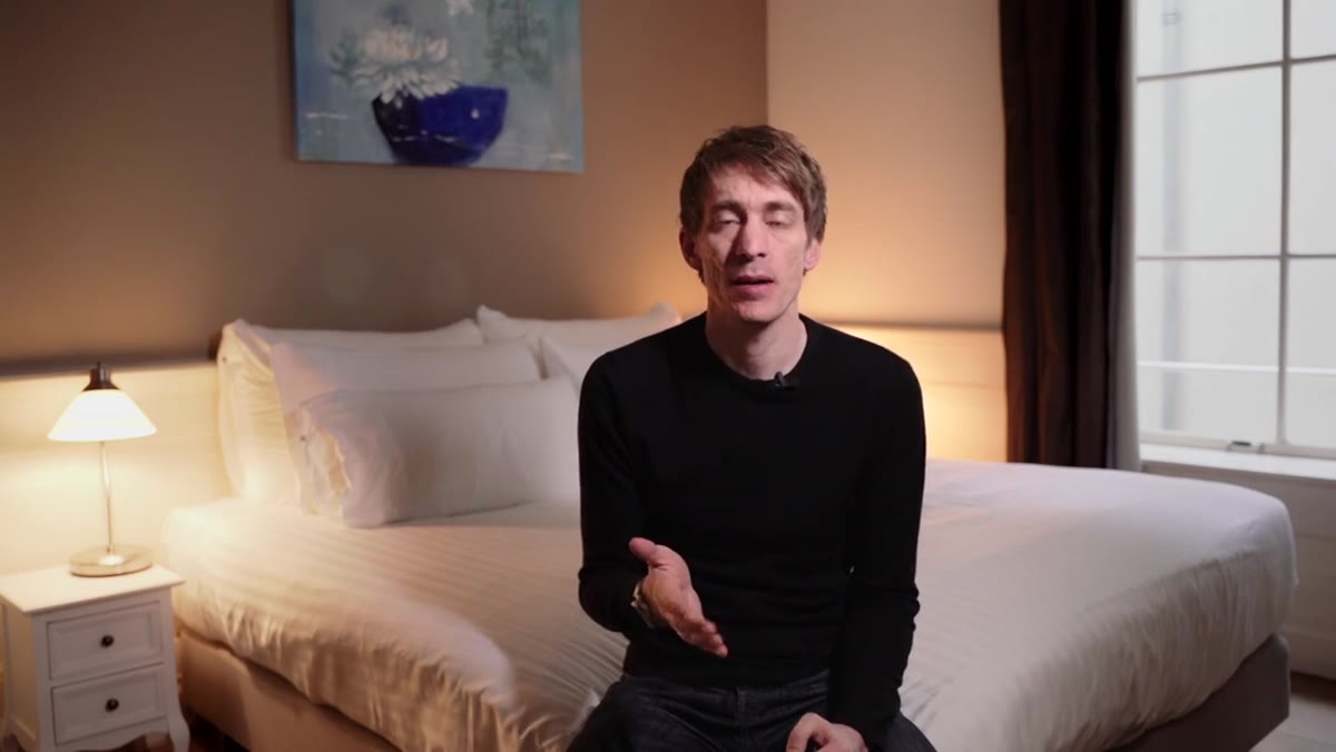 Tucker holds Sony a7 III with small pancake lens attached