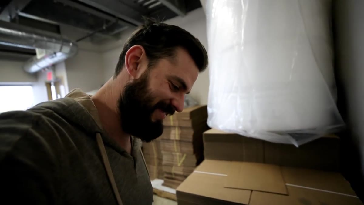 Peter loading materials into his truck outside the shop