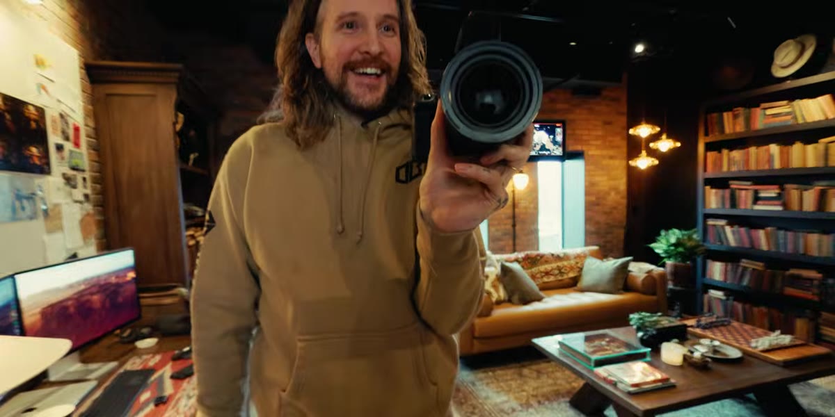 Peter McKinnon holding up three cameras side by side